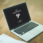 Laptop screen showing maintenance message with wrench and gear icon, related to sewer main maintenance in Colorado Springs.