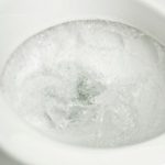 Clean toilet bowl filled with swirling, frothy water, emphasizing sanitation for homeowners seeking plumbing solutions.
