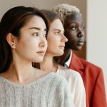 Diverse individuals with unique hairstyles representing women in plumbing, showcasing individuality and contributions.
