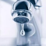 Sleek metallic faucet with water droplet, highlighting plumbing issues and conservation from B&L Plumbing.