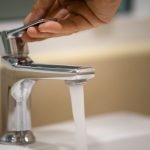 Chrome-plated faucet with clear water flowing, showcasing essential plumbing services by B&L Plumbing.