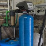Water softener system featuring a blue tank and digital control panel, illustrating the benefits of softened water for skin and hair care, relevant to B&L Plumbing and Heating's services in Colorado Springs, CO.